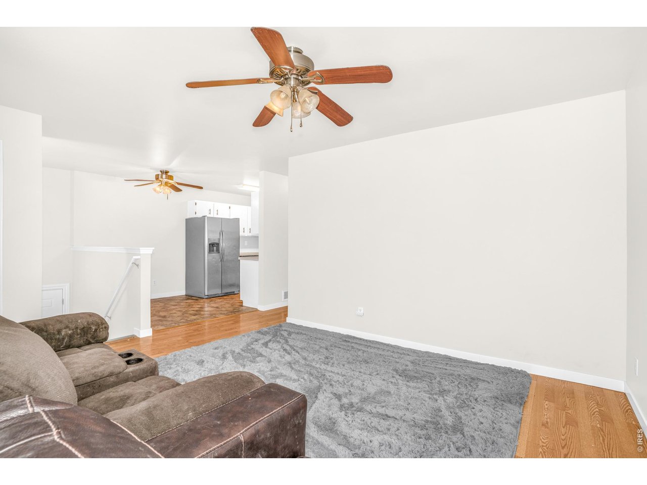 526 East 23rd Street Road Greeley, CO 80631 - Photo 9 of 20 a living room with furniture and a chandelier