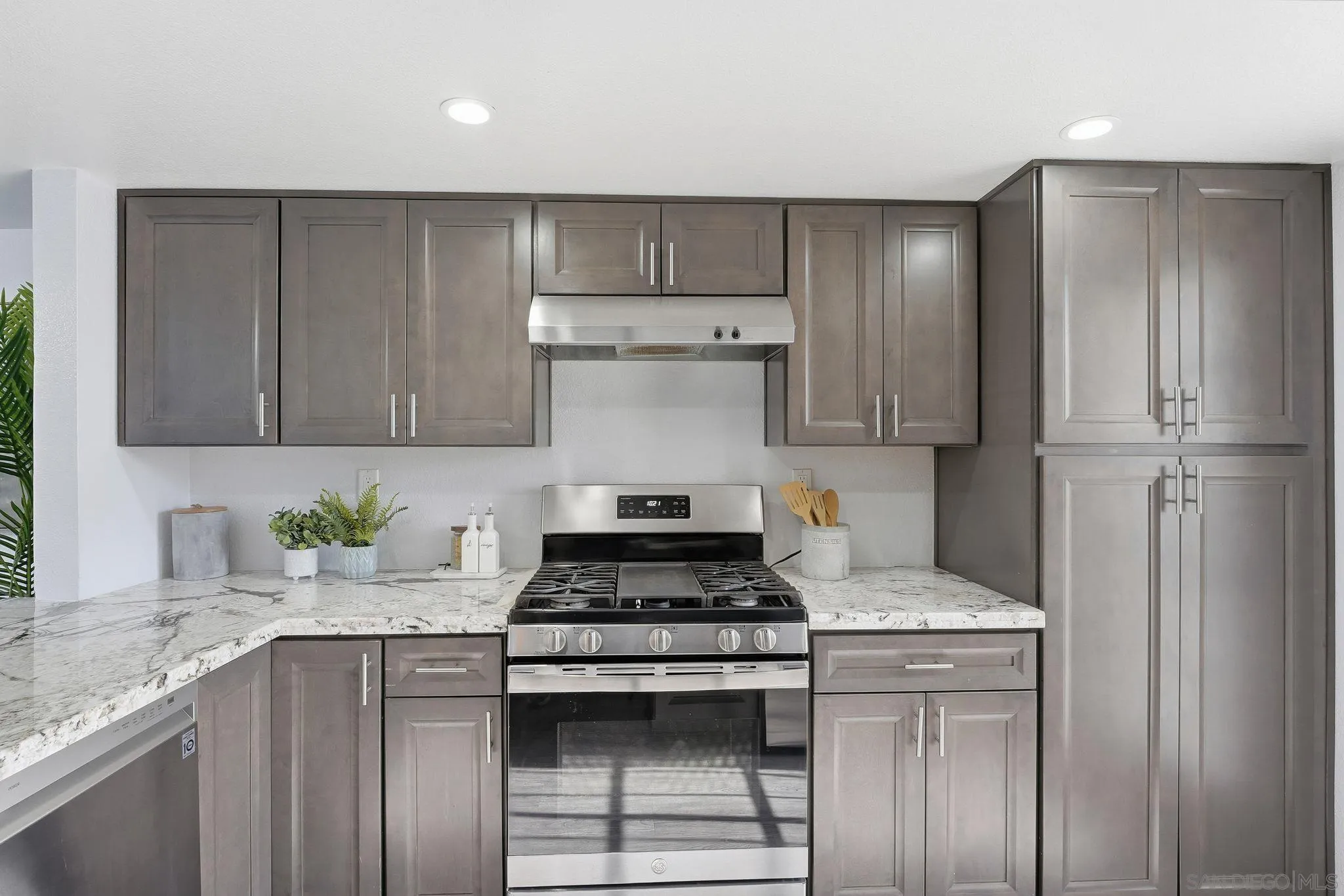8753 Spring Canyon Drive Spring Valley, CA 91977 - Photo 13 of 43 a kitchen with stainless steel appliances granite countertop a stove and a refrigerator