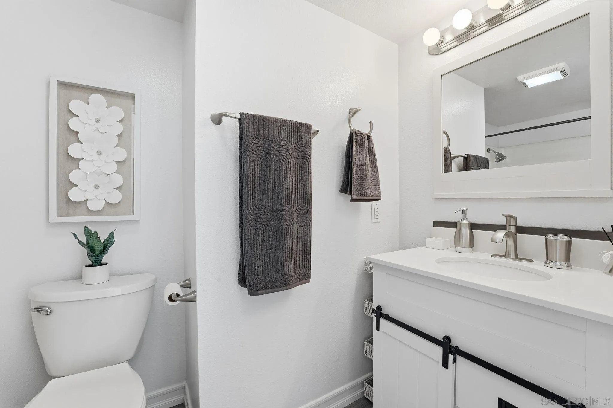 8753 Spring Canyon Drive Spring Valley, CA 91977 - Photo 29 of 43 a bathroom with a sink toilet and a mirror