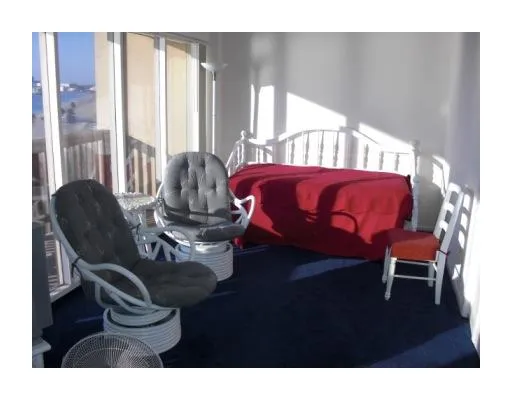 a picture of a living room with a floor to ceiling window and wooden floor