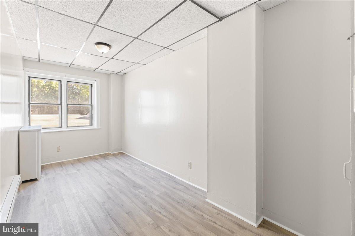 245 Warren Street Beverly, NJ 08010 - Photo 13 of 20 an empty room with wooden floor and windows