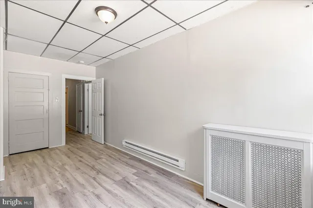 a view of a room with wooden floor