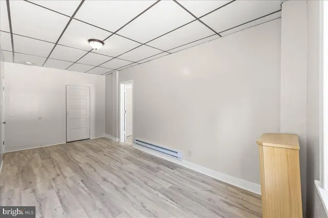 a view of a room with wooden floor