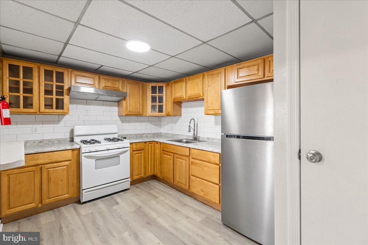 245 Warren Street Beverly, NJ 08010 - Photo 8 of 20 a kitchen with stainless steel appliances white cabinets and a refrigerator