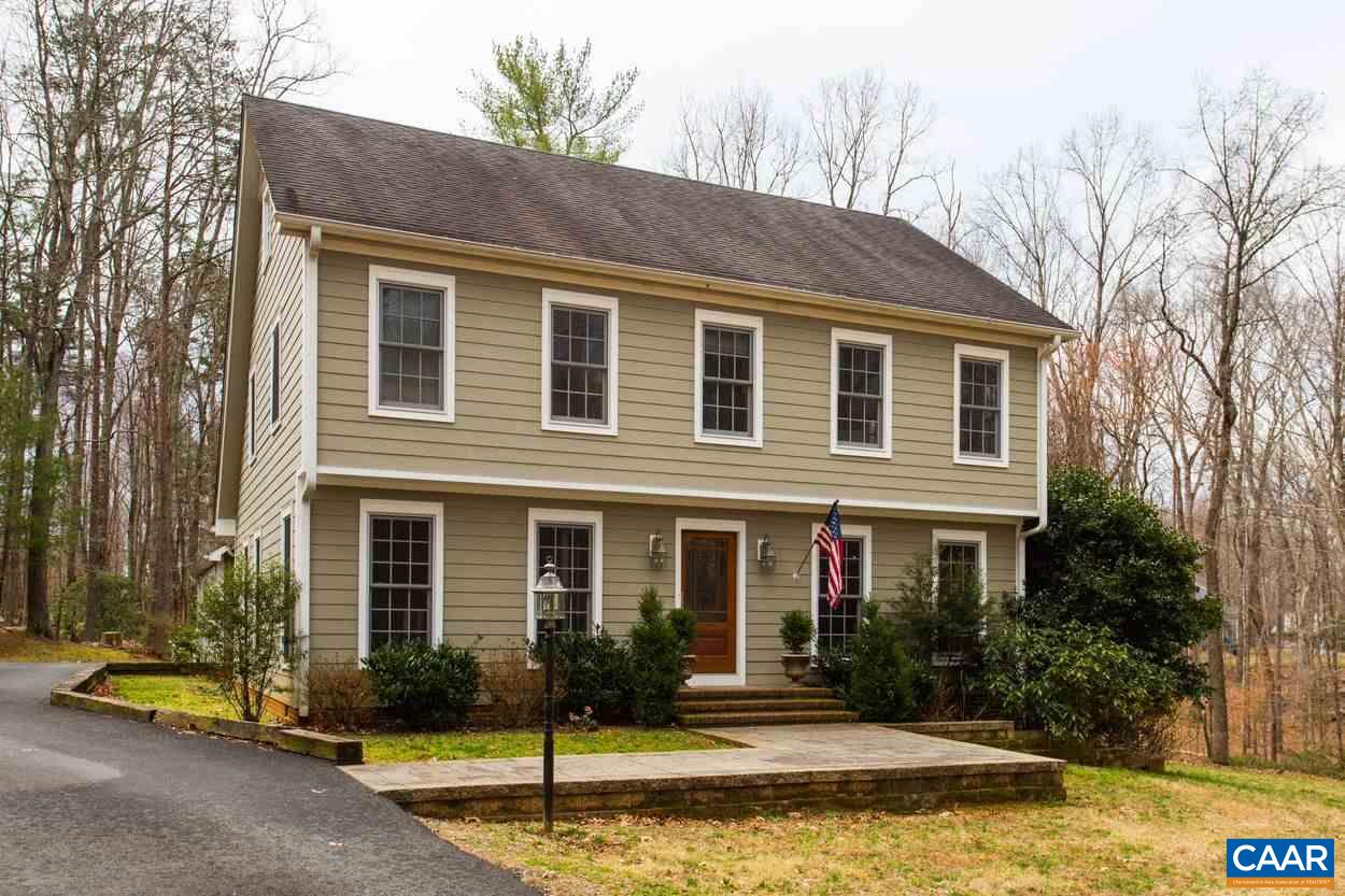a front view of a house with swimming pool and porch