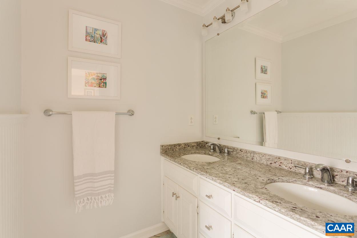 2485 Thrush Road Charlottesville, VA 22901 - Photo 18 of 23 a bathroom with a granite countertop sink and a mirror