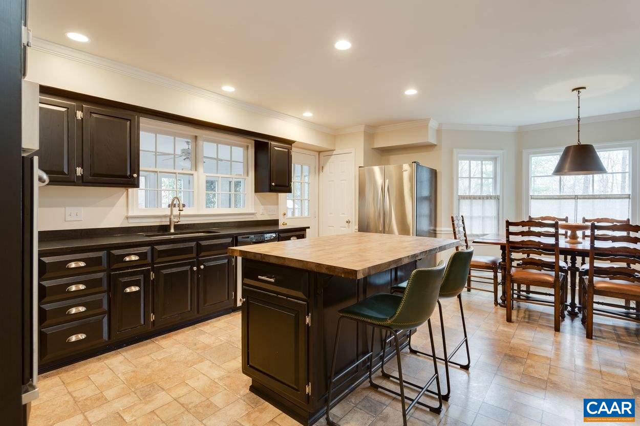2485 Thrush Road Charlottesville, VA 22901 - Photo 8 of 23 a kitchen with stainless steel appliances granite countertop a stove a sink a oven a dining table and chairs