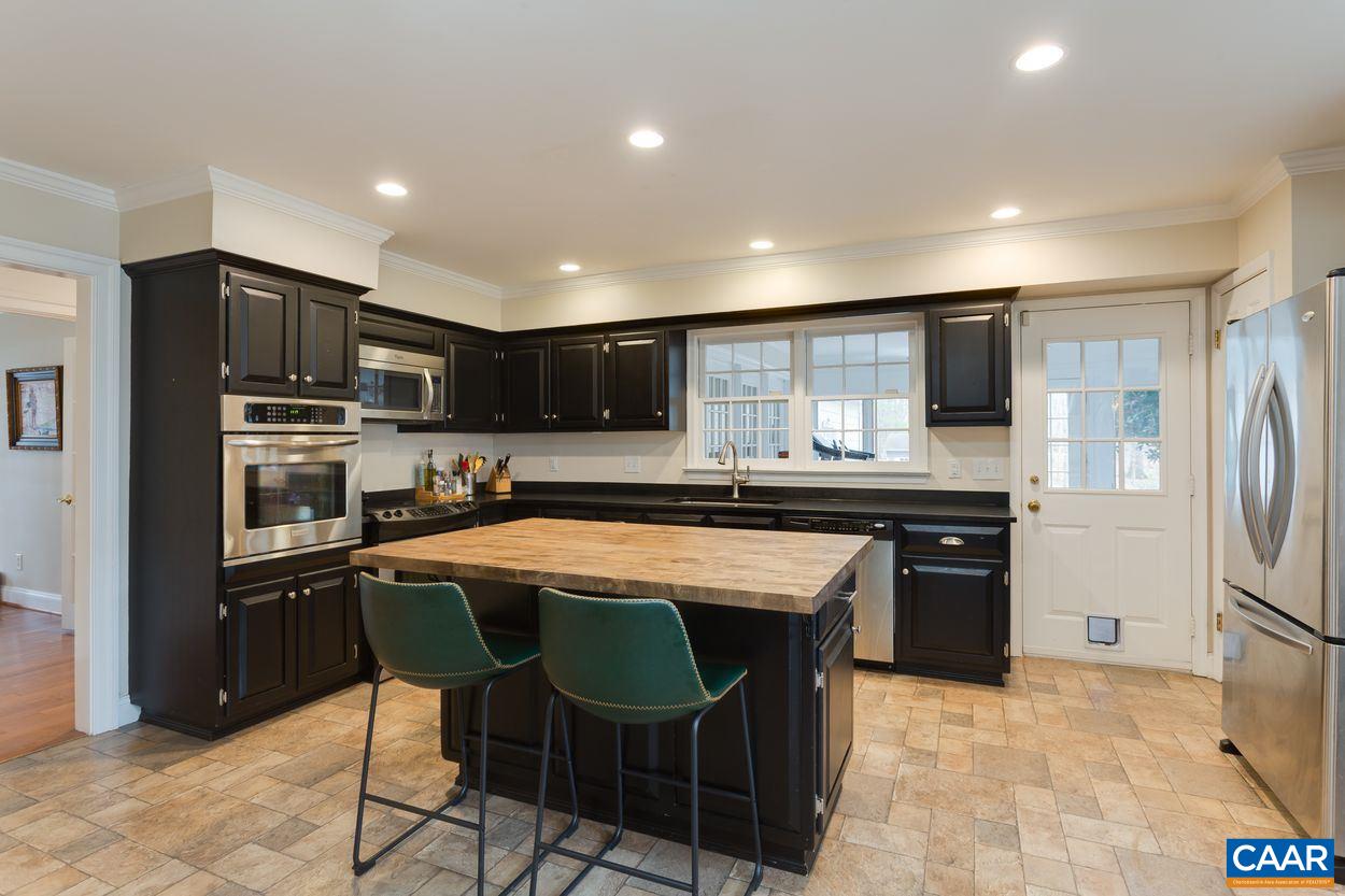 2485 Thrush Road Charlottesville, VA 22901 - Photo 9 of 23 a kitchen with stainless steel appliances granite countertop a sink and a refrigerator