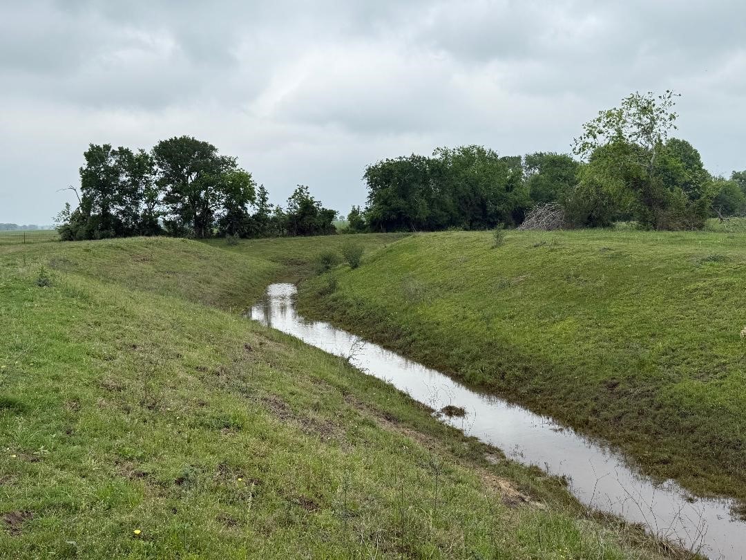 10542 Walker Road Beasley, TX 77417 - Photo 3 of 11 a view of a golf course with a lake