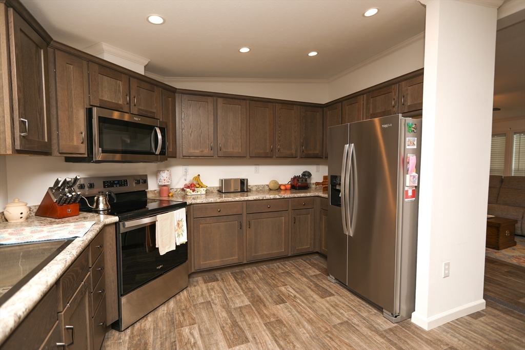 3 B Street Merrimac, MA 01860 - Photo 14 of 41 a kitchen with granite countertop stainless steel appliances and wooden cabinets