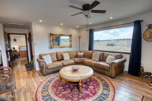 a living room with furniture and a large window