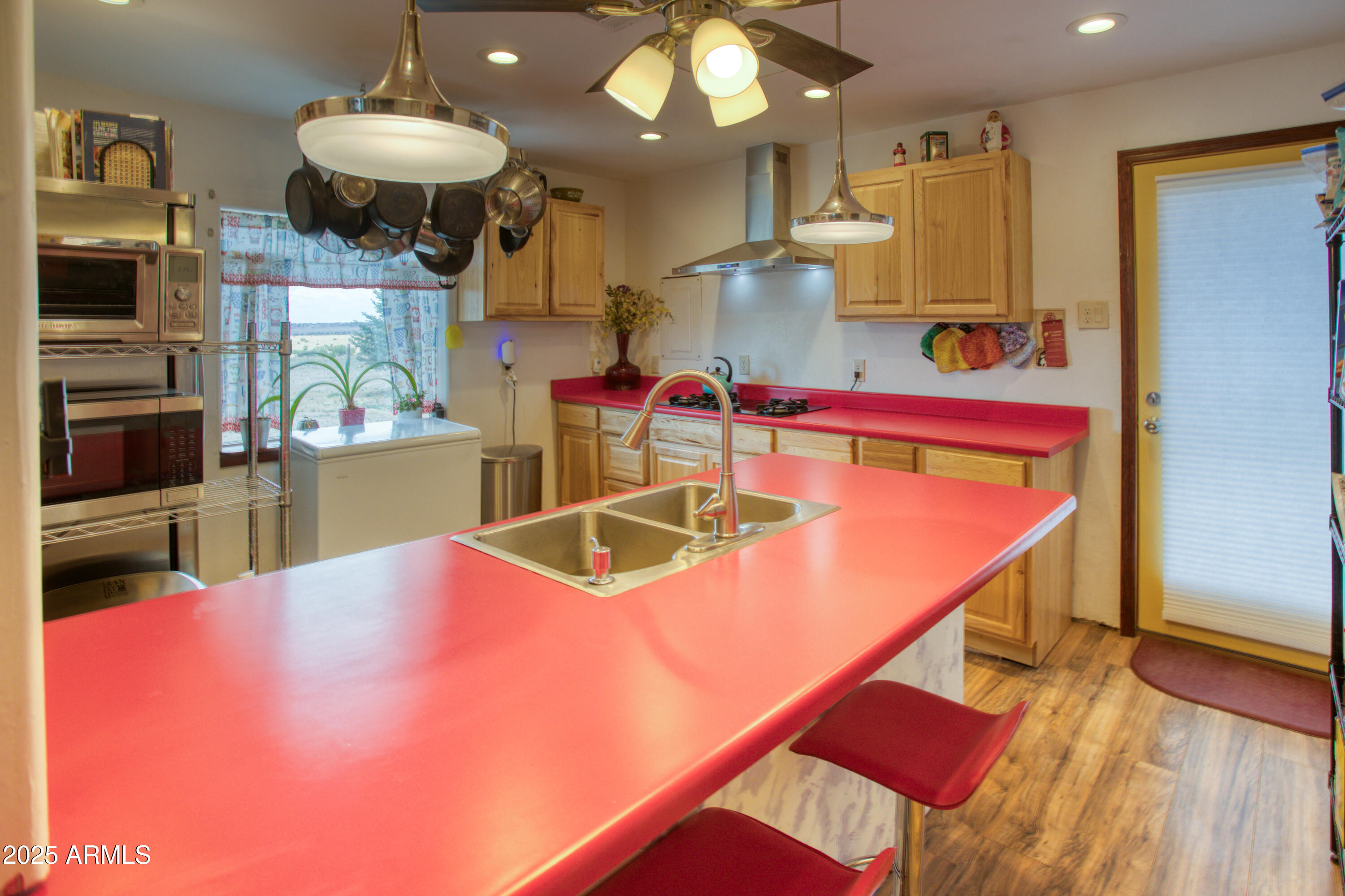70 N5207 Concho, AZ 85924 - Photo 8 of 28 a kitchen with stainless steel appliances kitchen island granite countertop a table and chairs in it