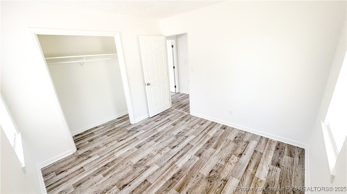 666 Jacobs Road Maxton, NC 28364 - Photo 12 of 30 a view of a room with wooden floor and brick wall
