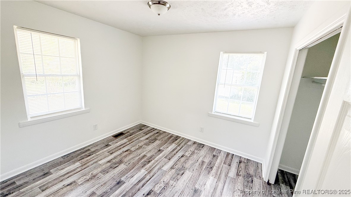 666 Jacobs Road Maxton, NC 28364 - Photo 13 of 30 a view of a room with wooden floor and a window
