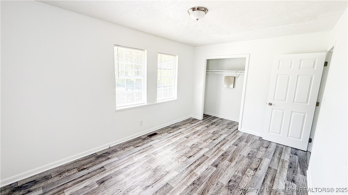 666 Jacobs Road Maxton, NC 28364 - Photo 14 of 30 a view of a room with wooden floor and window