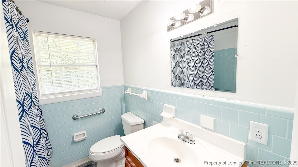 666 Jacobs Road Maxton, NC 28364 - Photo 16 of 30 a white toilet sitting next to a bathroom sink