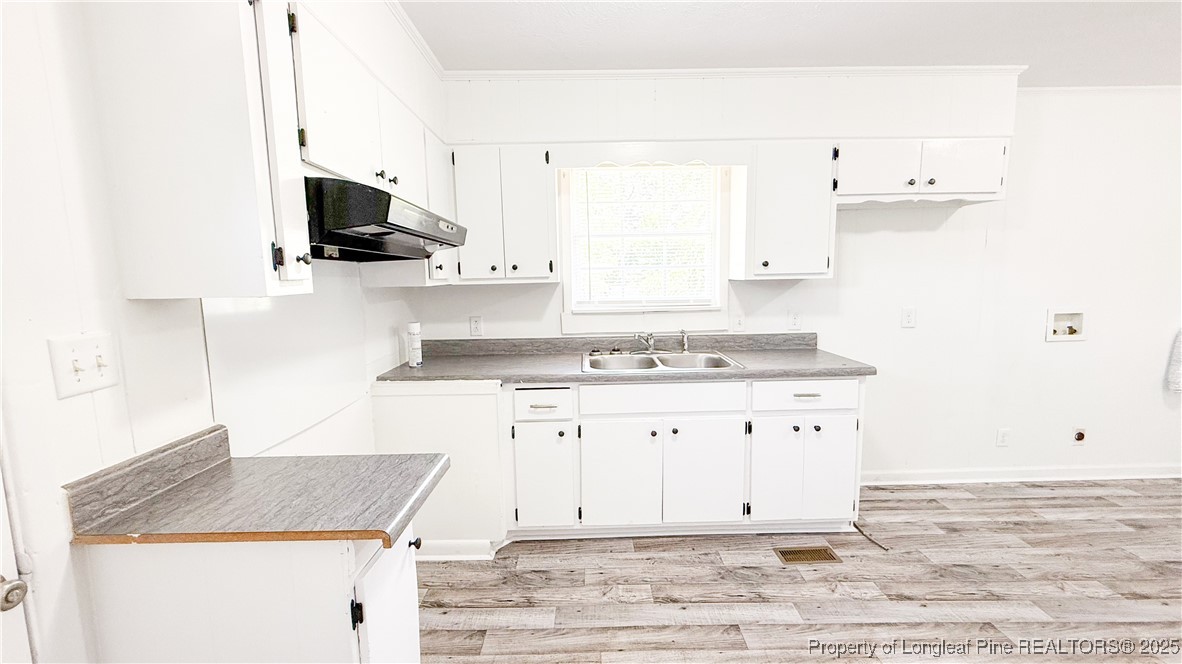 666 Jacobs Road Maxton, NC 28364 - Photo 22 of 30 a kitchen with granite countertop white cabinets and a stove