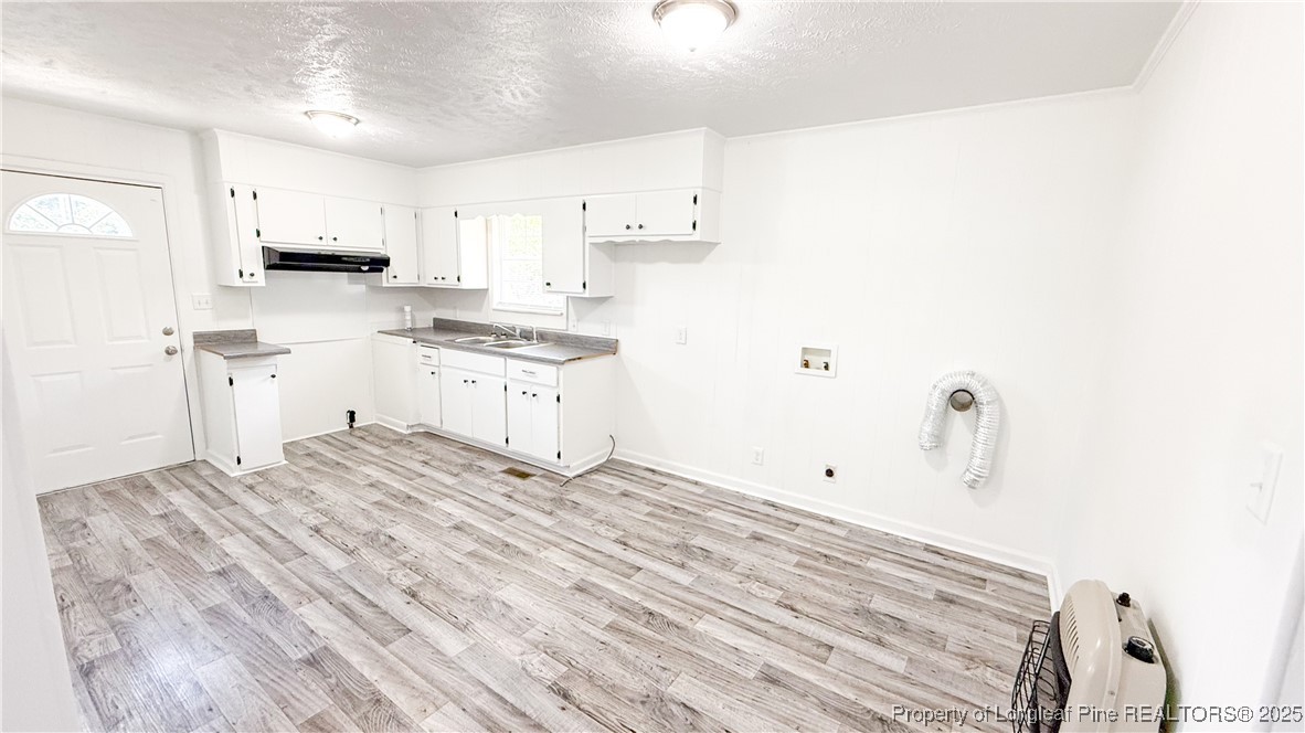666 Jacobs Road Maxton, NC 28364 - Photo 24 of 30 a kitchen with granite countertop white cabinets and white appliances