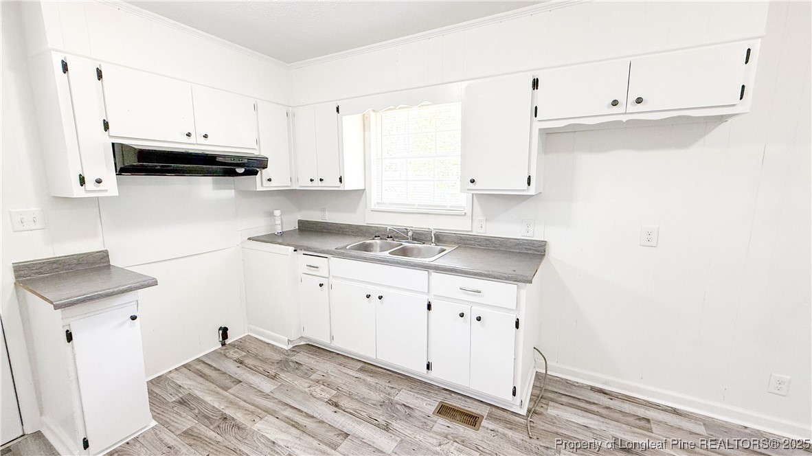 666 Jacobs Road Maxton, NC 28364 - Photo 25 of 30 a kitchen with granite countertop white cabinets and white appliances