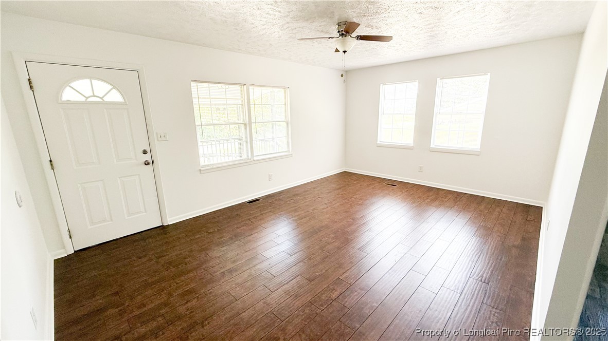 666 Jacobs Road Maxton, NC 28364 - Photo 27 of 30 a view of an empty room with wooden floor and a window