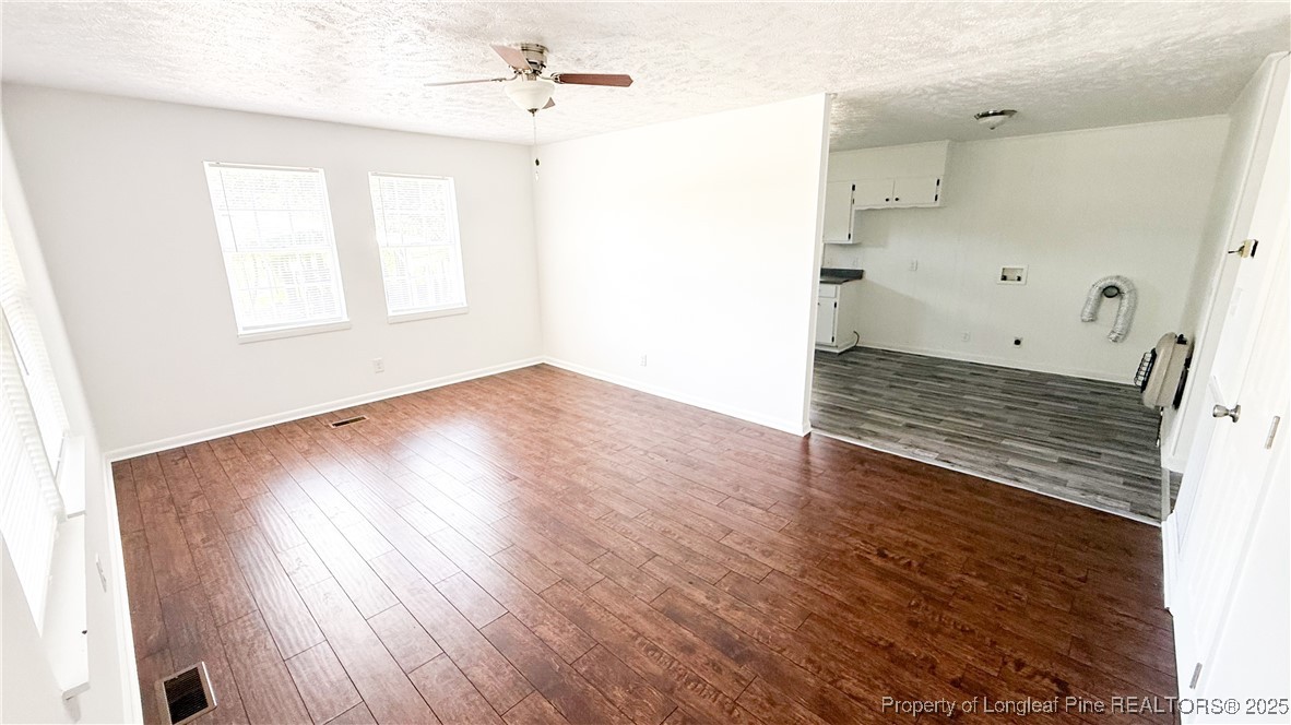 666 Jacobs Road Maxton, NC 28364 - Photo 29 of 30 a view of an empty room with wooden floor and a window