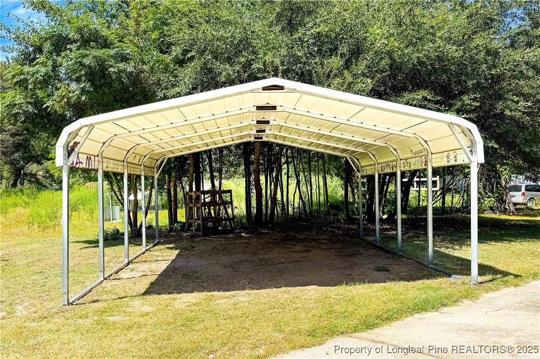 666 Jacobs Road Maxton, NC 28364 - Photo 9 of 30 a view of a house with backyard and porch