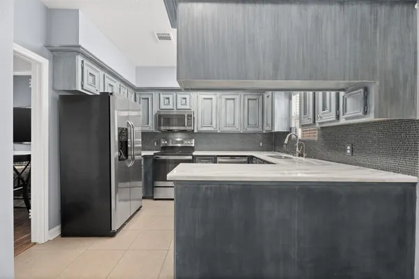 a kitchen with a refrigerator a stove and a sink