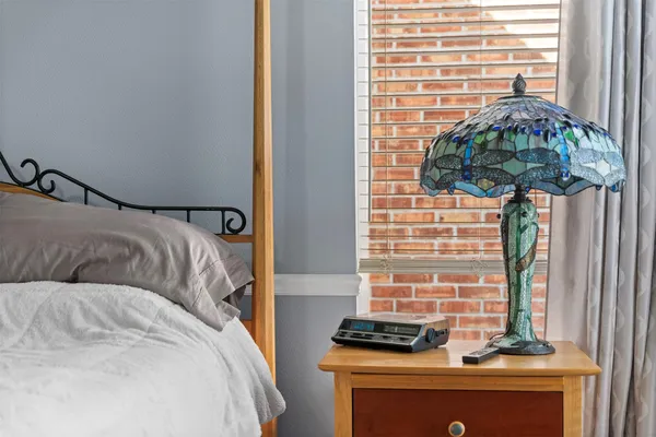a bedroom with a bed and a window
