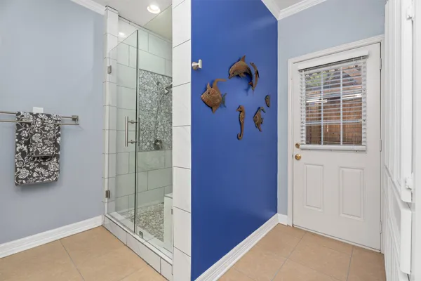 wooden floor with a glass shower door