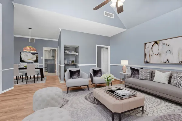 a living room with furniture and view of kitchen