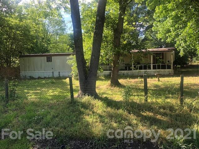 1471 Memorial Park Road Lancaster, SC 29720 - Photo 2 of 3 a view of a backyard with large trees and plants
