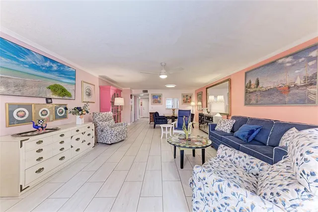 a bedroom with a bed painting on wall and a large window