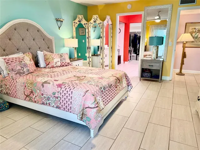 a bedroom with a bed and flat screen tv