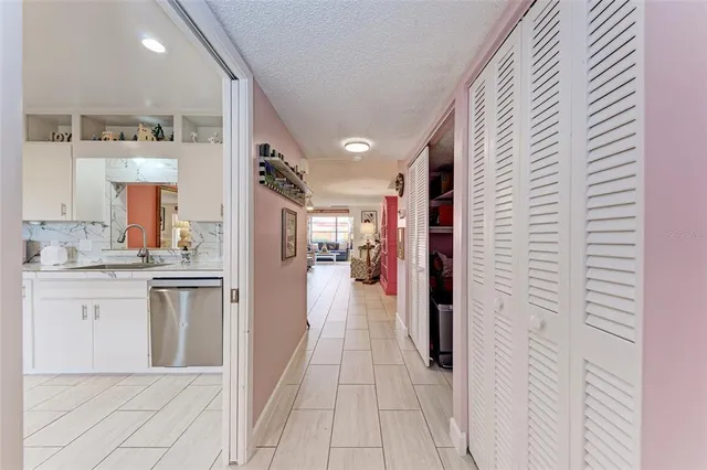 a bedroom with a bed and paintings on the wall
