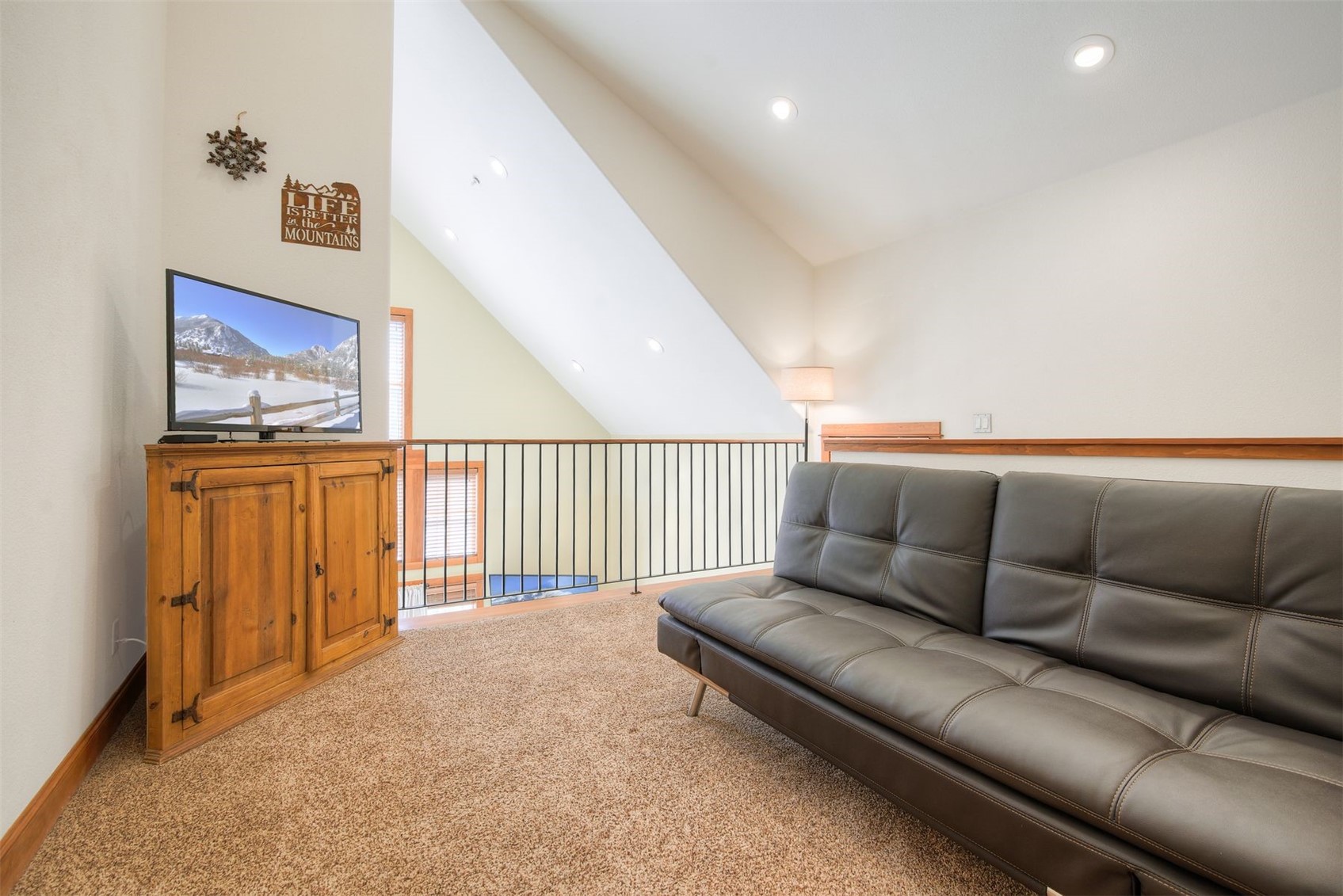 71 Antlers Gulch Road, Unit 303 Keystone, CO 80435 - Photo 19 of 35 a living room with furniture and a flat screen tv