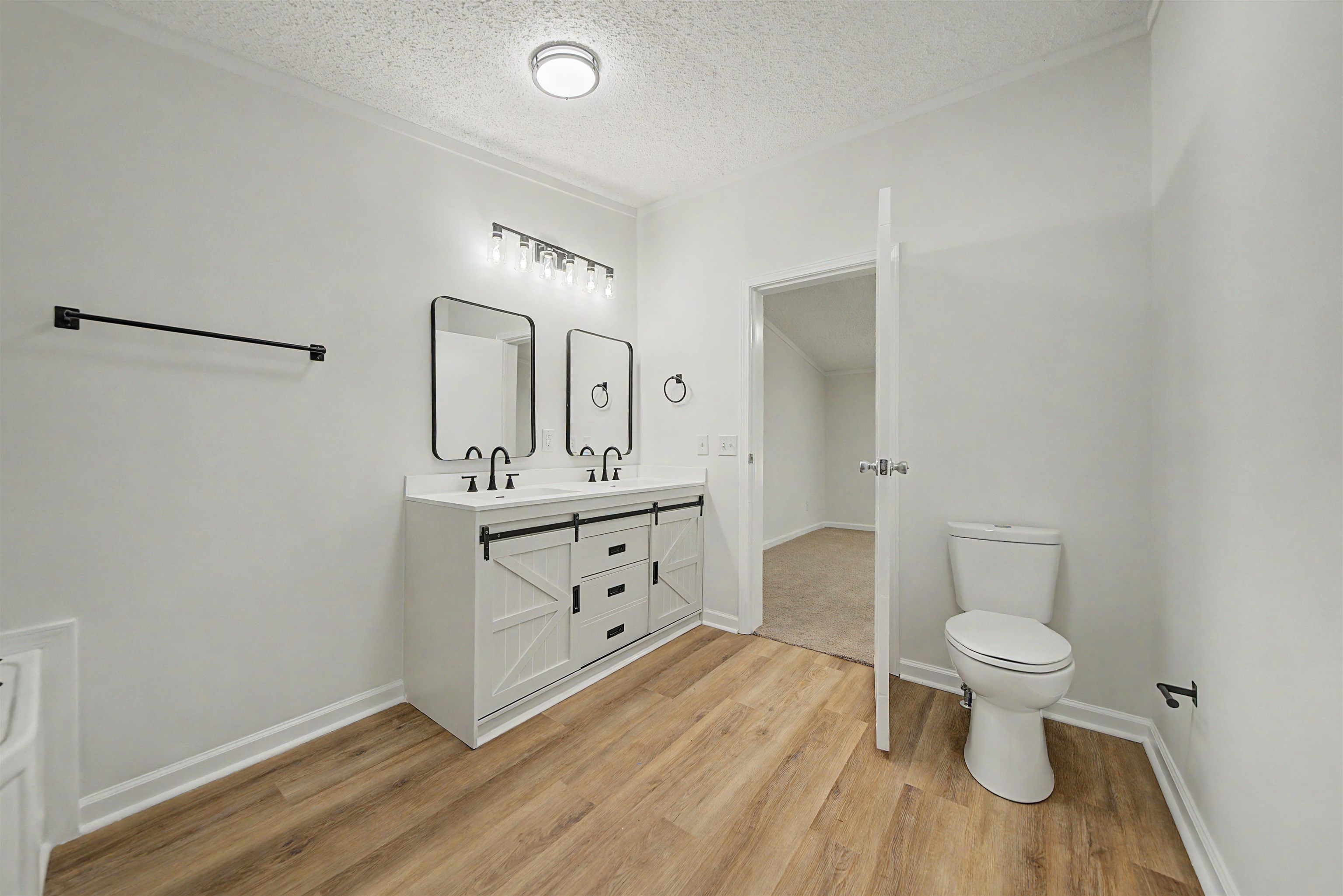 890 Burks Road Savannah, TN 38372 - Photo 16 of 40 a bathroom with a double vanity sink toilet and a mirror
