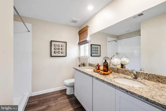 a dining room with granite countertop a sink and a mirror