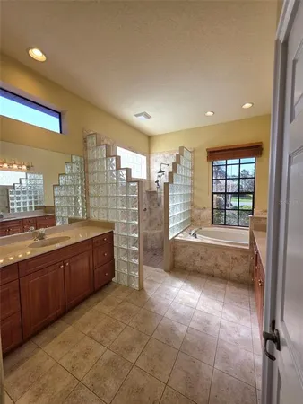 a large spacious bathroom with a large tub and shower