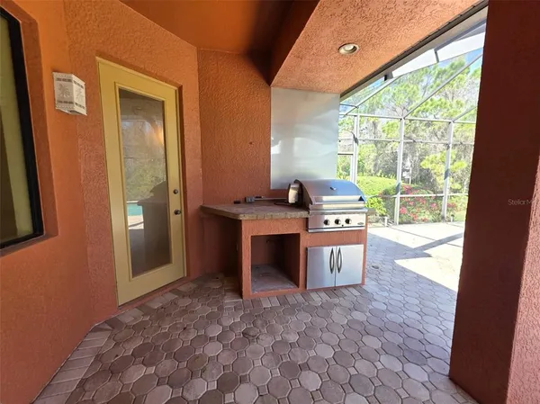 a view of an empty room with a fireplace and a window