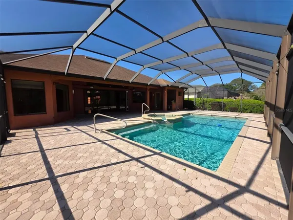 a view of a backyard with table and chairs under an umbrella