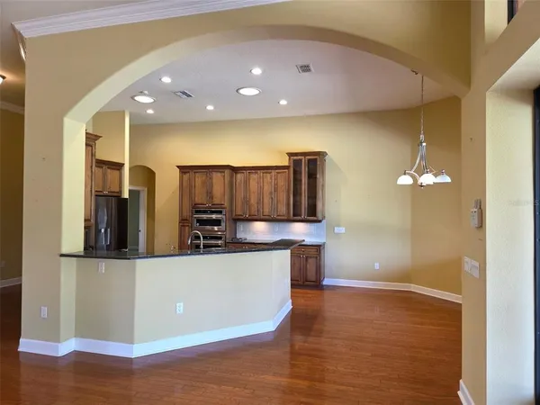 a kitchen with stainless steel appliances a refrigerator and a microwave