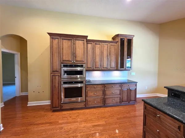 a kitchen with stainless steel appliances granite countertop a stove and a refrigerator