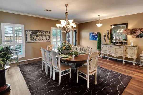 a kitchen with granite countertop white cabinets stainless steel appliances and sink
