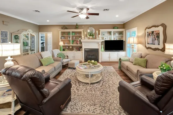 a kitchen with granite countertop a table chairs stove and refrigerator