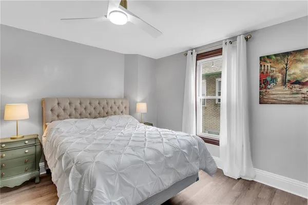 a large bed sitting in a bedroom next to a lamp