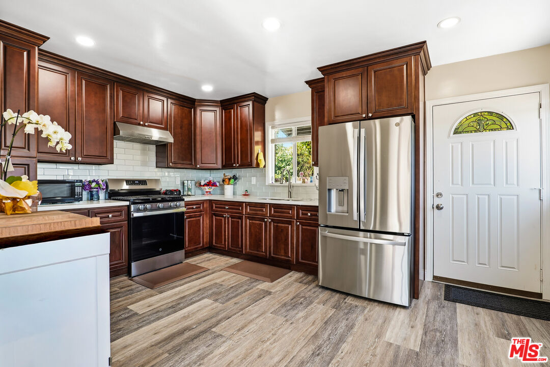 1969 Heidleman Road Los Angeles, CA 90032 - Photo 5 of 18 a kitchen with stainless steel appliances granite countertop a refrigerator stove and wooden floor