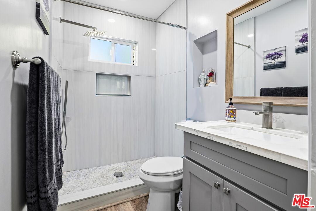 1969 Heidleman Road Los Angeles, CA 90032 - Photo 7 of 18 a bathroom with a granite countertop sink toilet and shower