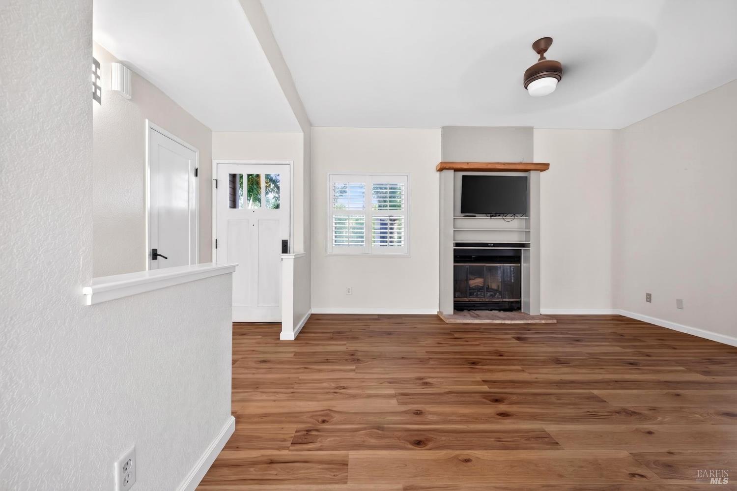2757 Lakeview Drive Santa Rosa, CA 95405 - Photo 8 of 54 a view of empty room with wooden floor and fireplace