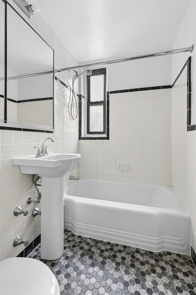 1420 York Avenue, Unit 4B Manhattan, NY 10021 - Photo 4 of 9 a bathroom with a sink toilet and shower