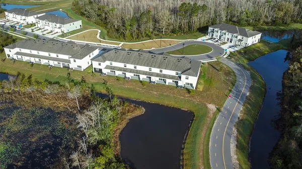 a view of a swimming pool with a yard and plants